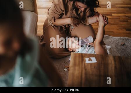 Mother spending quality time with daughters at home Stock Photo