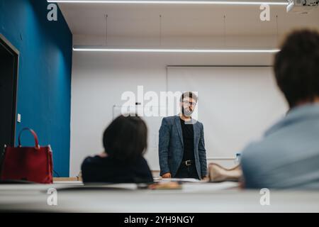 Professor assisting students during a classroom lesson Stock Photo