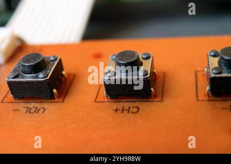 Tactile switches on an electronic circuit board. Tact buttons in a row. Stock Photo