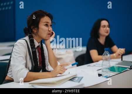 Attentive students listening during a classroom lecture session Stock Photo