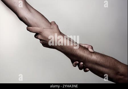 Support hands. Helping support hand. Rescue gesture. Support hand. Concept of support. Strong hold. Two hands, helping hand of a friend. Stock Photo