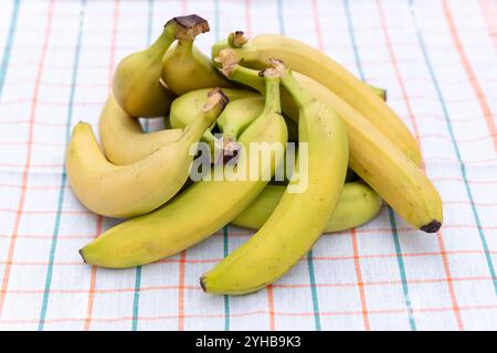 Ripe yellow bananas on white table cloth view from above Stock Photo