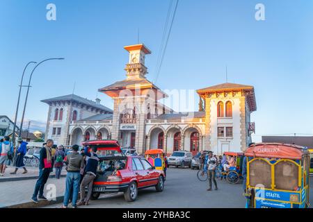 Antsirabe, Madagascar - August 30, 2024: The now decommissioned Antsirabe railway station is a testament to the city's history. People gathered around Stock Photo