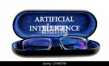 The concept of technology and development. Phrase, word, text ARTIFICIAL INTELLIGENCE written on the open case of the glasses case. Stock Photo