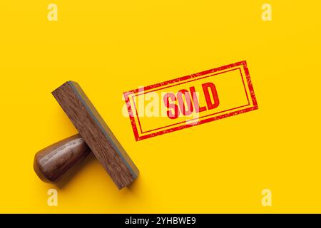 Rubber stamp on yellow background with red sold sign, symbolizing successful business transaction. 3d render. Stock Photo