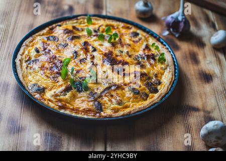 Homemade Quiche or chicken and mushroom pie according to a traditional French recipe on a wooden background. High quality photo Stock Photo