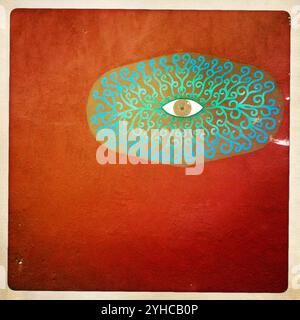 An eye decorates an orange wall in Malinalco,  Mexico State, Mexico, January 6, 2013. PLEASE NOTE: This image is part of Aurora's myPhone Collection of images taken with mobile d Stock Photo