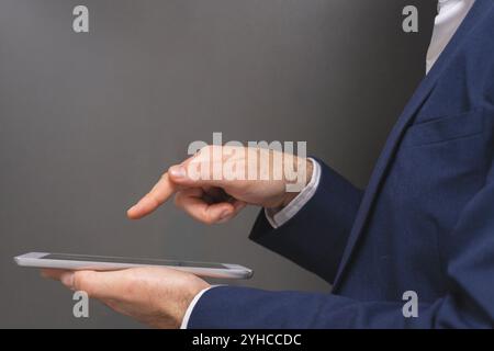 Close-up of businessman using digital tablet while standing in locker room Stock Photo