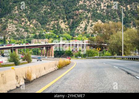 Glenwood Springs, USA - September 29, 2022: Colorado highway road with cars traffic driving in mountain town city of Glenwood Springs Stock Photo