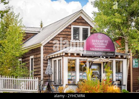 Mount Crested Butte, USA - September 29, 2022: Colorado village downtown in fall autumn with foliage and sign for Berkshire Hathaway real estate Stock Photo