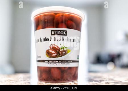 Avon, USA - August 13, 2022: Krinos bulk brand of pitted Kalamata olives in brine macro closeup with bokeh background Stock Photo