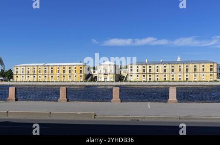 The building of the old hemp warehouses on Tuchkovoy Buyan. View from the Makarov Embankment through the Malaya Neva River. Saint Petersburg, Russia, Stock Photo