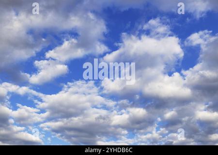 Blue sky with lots of white to grey clouds Stock Photo