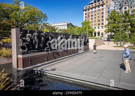 WASHINGTON DC, United States — The sculptural relief panel at the National World War I Memorial depicts scenes from 'A Soldier's Journey,' telling the story of American involvement in World War I. Located at the former Pershing Park site on Pennsylvania Avenue, this bronze installation was unveiled in 2024. The high-relief sculpture presents detailed scenes of military service and sacrifice. Stock Photo