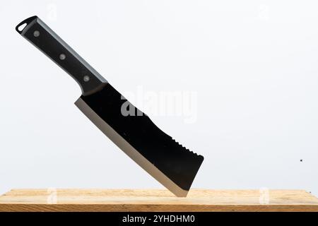 Kitchen knife on wooden board isolated on white background Stock Photo