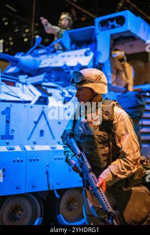 FORT BELVOIR, Virginia — The Bradley Fighting Vehicle exhibit at the National Museum of the United States Army showcases both M2 and M3 variants. The display features technical specifications and combat modifications, including an M2A3 Bradley equipped with reactive armor and electronic warfare systems used in Mosul, Iraq. The exhibit demonstrates the vehicle's evolution in modern urban warfare. Stock Photo