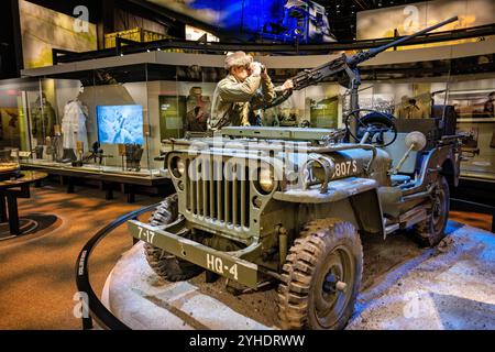 FORT BELVOIR, Virginia — The World War II Jeep exhibit at the National Museum of the United States Army showcases the iconic military vehicle that revolutionized battlefield transportation. The display details the technical specifications of the Willys MB and Ford GPW models, which saw production of over 600,000 units during World War II. The exhibit highlights the Jeep's versatility as a command vehicle, weapons carrier, and ambulance. Stock Photo