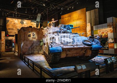 FORT BELVOIR, Virginia — The Bradley Fighting Vehicle exhibit at the National Museum of the United States Army showcases both M2 and M3 variants. The display features technical specifications and combat modifications, including an M2A3 Bradley equipped with reactive armor and electronic warfare systems used in Mosul, Iraq. The exhibit demonstrates the vehicle's evolution in modern urban warfare. Stock Photo