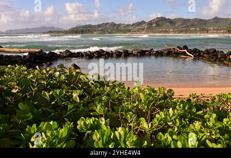 Small man made wading pool at Kapa'a Kauai with mountain range in the background Stock Photo