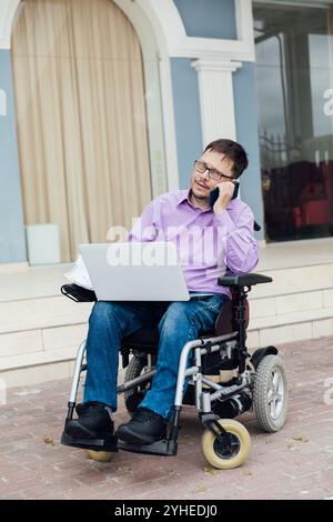 Man with in Wheelchair Working Laptop Stock Photo