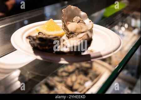 A freshly shucked seafood platter served with lemon showcasing authentic culinary experiences. Stock Photo