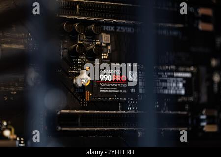 Lviv, Ukraine - October 30, 2024: Samsung SSD 990 PRO PCle 4.0 NVMe M.2 on motherboard background Stock Photo