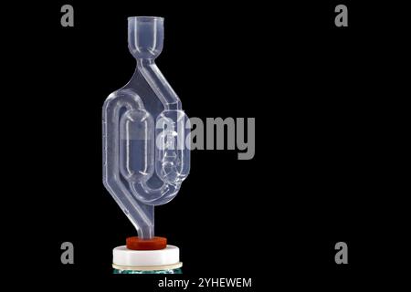 bubbling plastic fermentation tube on the wine balloon isolated on black background with copy space, Stock Photo