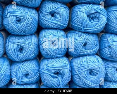 Close up view of balls of blue wool on display in a knitting shop.. Stock Photo