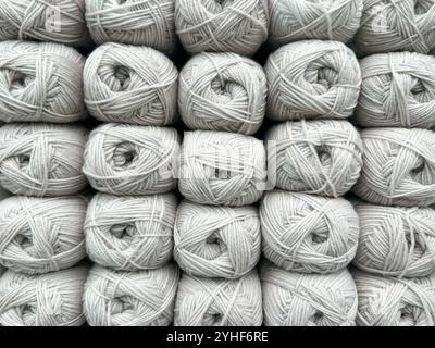 Close up view of balls of beige wool on display in a knitting shop Stock Photo