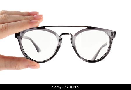 Woman holding glasses with grey frame on white background, closeup Stock Photo