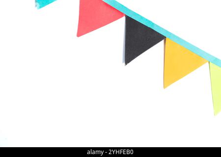 A vibrant row of colorful paper bunting flags isolated on a white background with copy space. Perfect for party invitations, celebration graphics, and Stock Photo