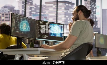 Employee utilizing AI resources and platforms to train and deploy machine learning models, handheld camera shot. Man monitoring and maintaining artificial intelligence company systems, camera A Stock Photo