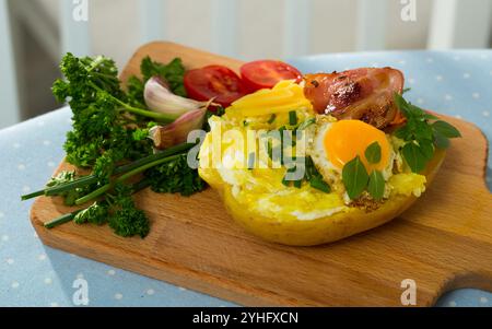 Tasty potato stuffed with eggs, bacon, cheese Stock Photo