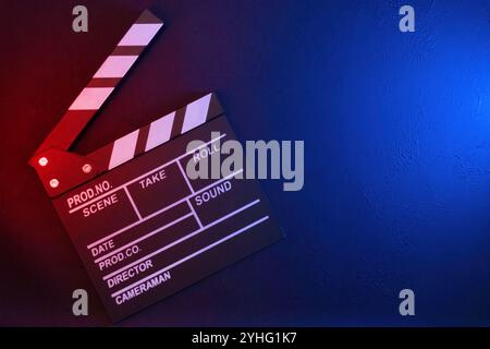 Clapperboard on black background with red and blue light, top view Stock Photo