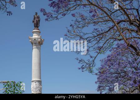 Monument of King Dom Pedro IV in Rossio Square, central and lively Lisbon square, with wavy paving in the city of Lisbon, capital of Portugal, Europe Stock Photo