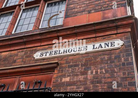 UK street sign of Steelhouse Lane, a well known street in Birmingham City Centre in the UK against an aged brick wall Stock Photo