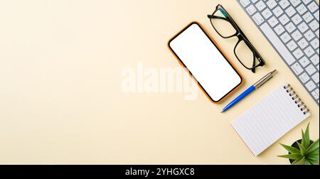 Office desk with computer keyboard, mouse, smartphone, notebook and pen. Top view with copy space. Flat lay Stock Photo