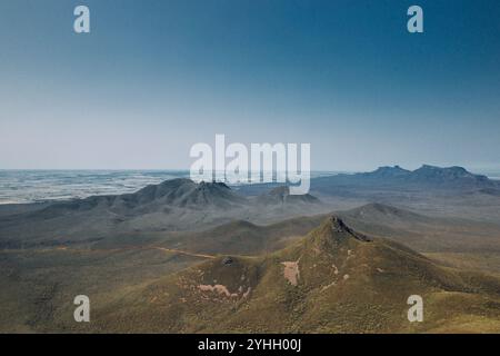 View from the top of Talyuberlup Peak in the Stirling Ranges, looking out over the other mountains. Clear blue sky, green flora and fauna. Stock Photo