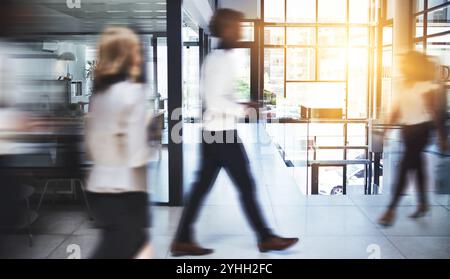 Business people, walking and speed with busy office for productive company, movement or rush. Group, employees or fast team moving with motion blur in Stock Photo