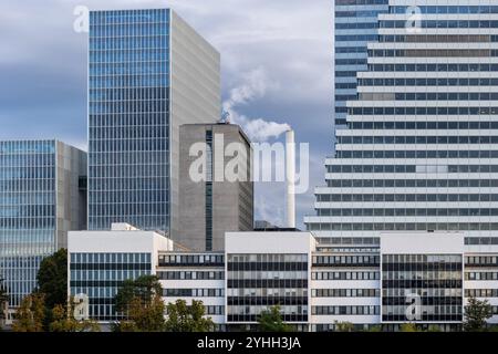 Basel, Switzerland - city downtown, corporate modern office buildings with smoking chimney in the middle. Stock Photo