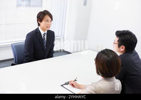 Interviewers and businessmen in suits being interviewed Stock Photo