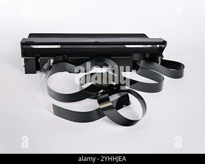 The video tape randomly sticks out of the video cassette case isolated on a white background. Stock Photo