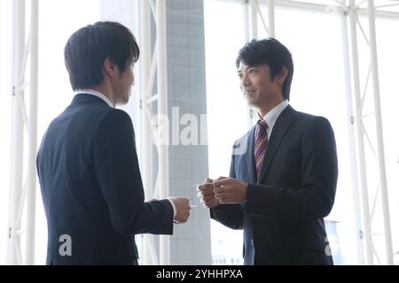 Two businessmen exchanging business cards Stock Photo