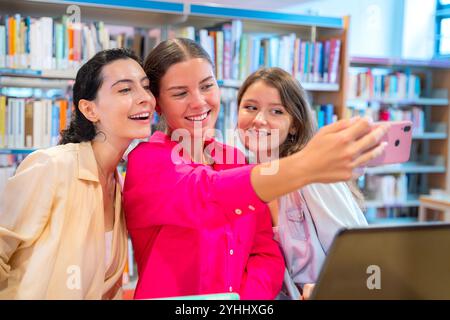 Happy Friends Taking Selfie in Library Stock Photo