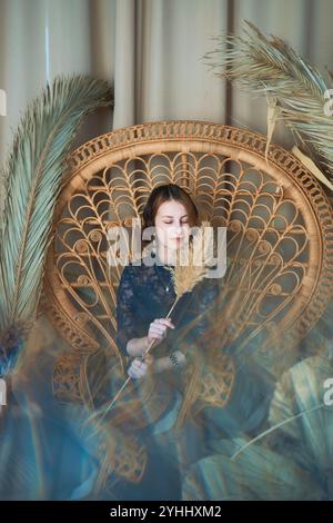 a teenage girl in a dress in a romantic location with dry reed stalks Stock Photo