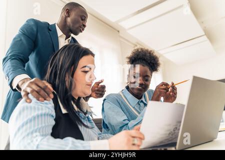 Diverse business team collaborating on project with senior executive manager leading discussion in modern corporate office Stock Photo
