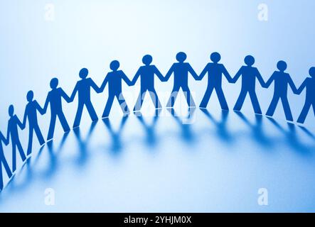 Paper people standing together hand in hand Stock Photo