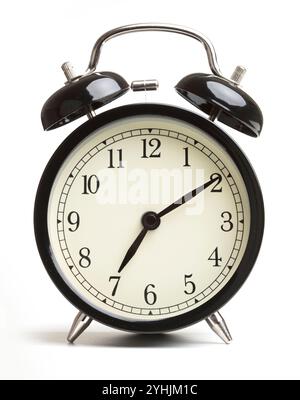 Old-fashioned alarm clock on white background Stock Photo - Alamy