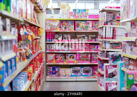 Firenze, Italy - November 11, 2020: Colorful toys fill shelves in a toy store aisle, creating a vibrant and enticing display for shoppers Stock Photo