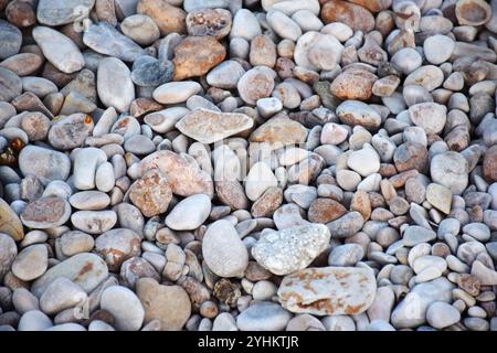 pebbles on the beach, smooth beach stones, coastal pebbles, beach stone patterns, colorful pebbles, pebble shorelines, seaside stones, pebble textures Stock Photo